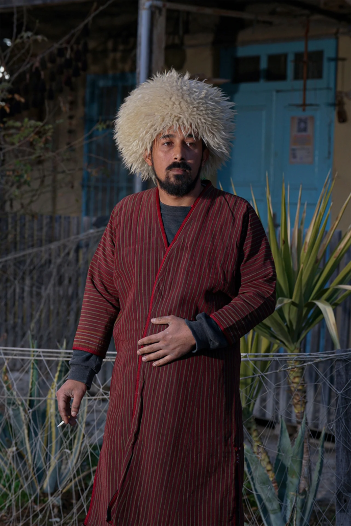 A Turkmen man dons his traditional clothing for our portrait photography project